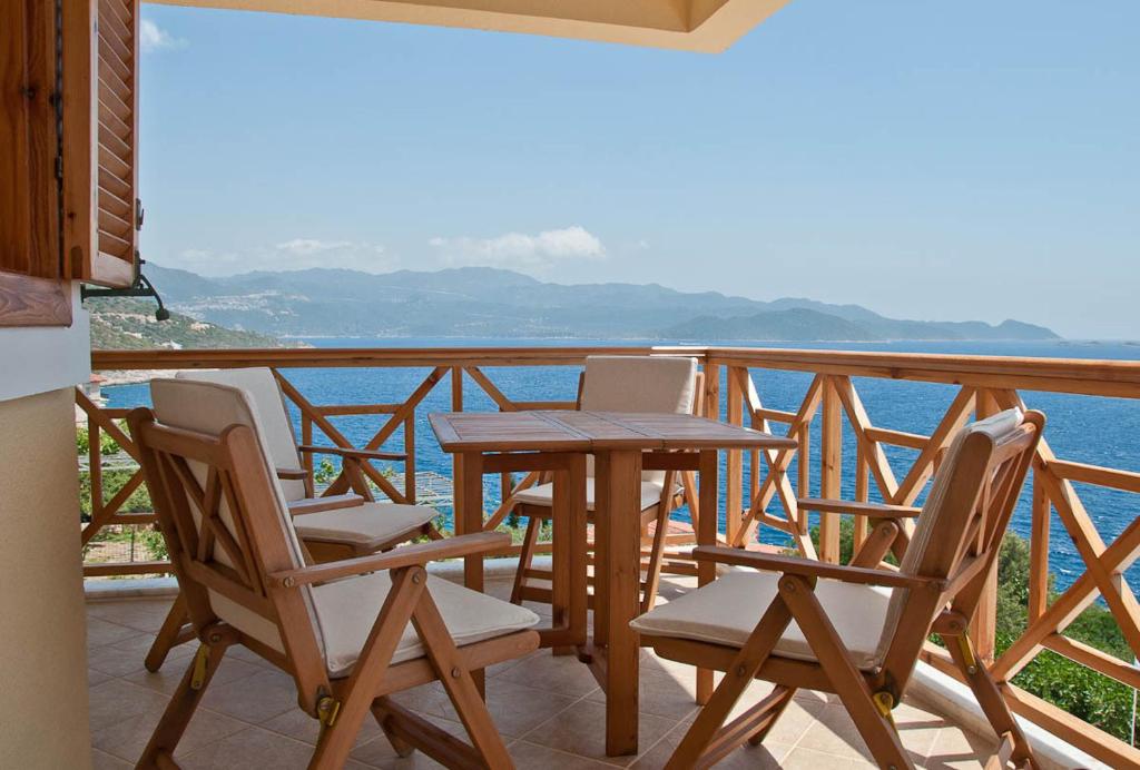 a table and chairs on a balcony overlooking the water at Lycia Hotel in Kaş