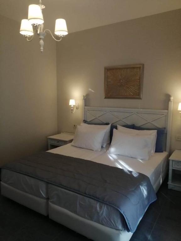 a bedroom with a large bed with two white pillows at Manolis&Xenia in Kefalos
