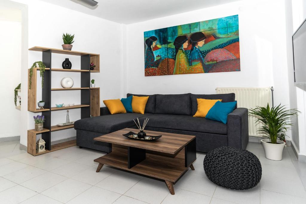 a living room with a couch and a coffee table at Maisonette near Heraklion Center Candia Maisonette in Heraklio Town