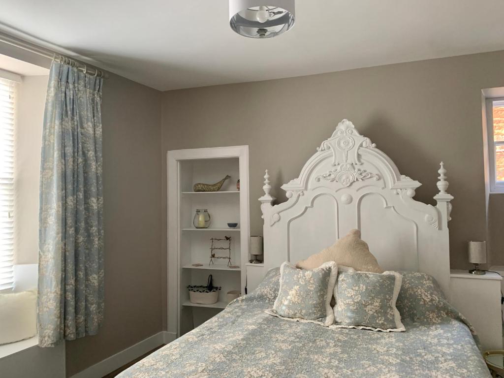 a bedroom with a large white bed with pillows at The Beach Pad North Berwick in North Berwick
