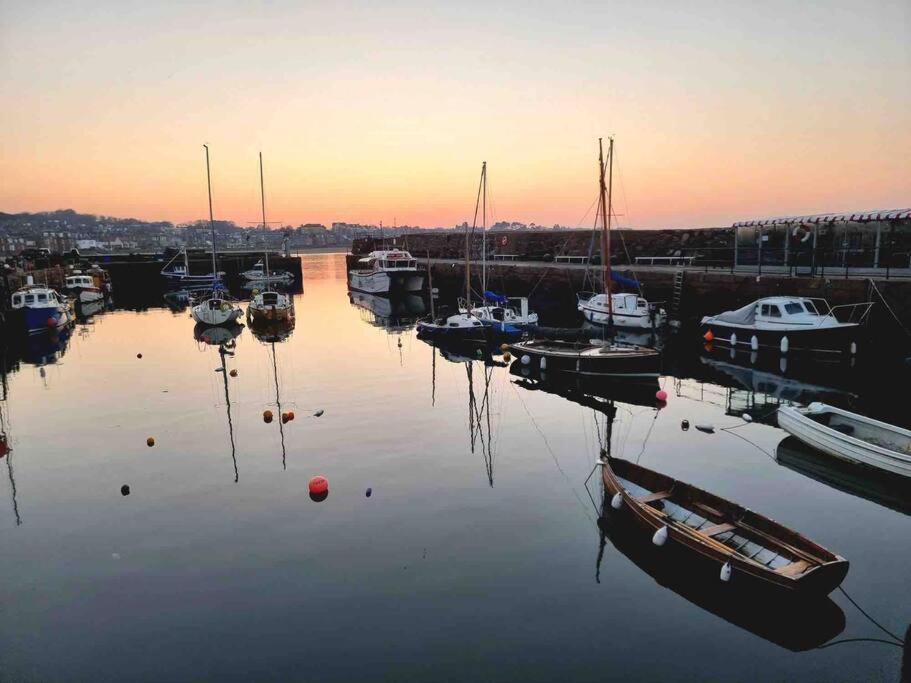 a group of boats are docked in a harbor at The Beach Pad North Berwick in North Berwick