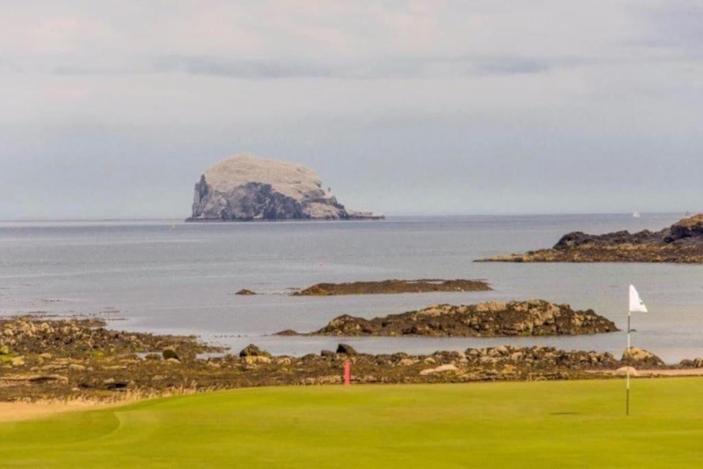 a golf course with an island in the water at The Beach Pad North Berwick in North Berwick