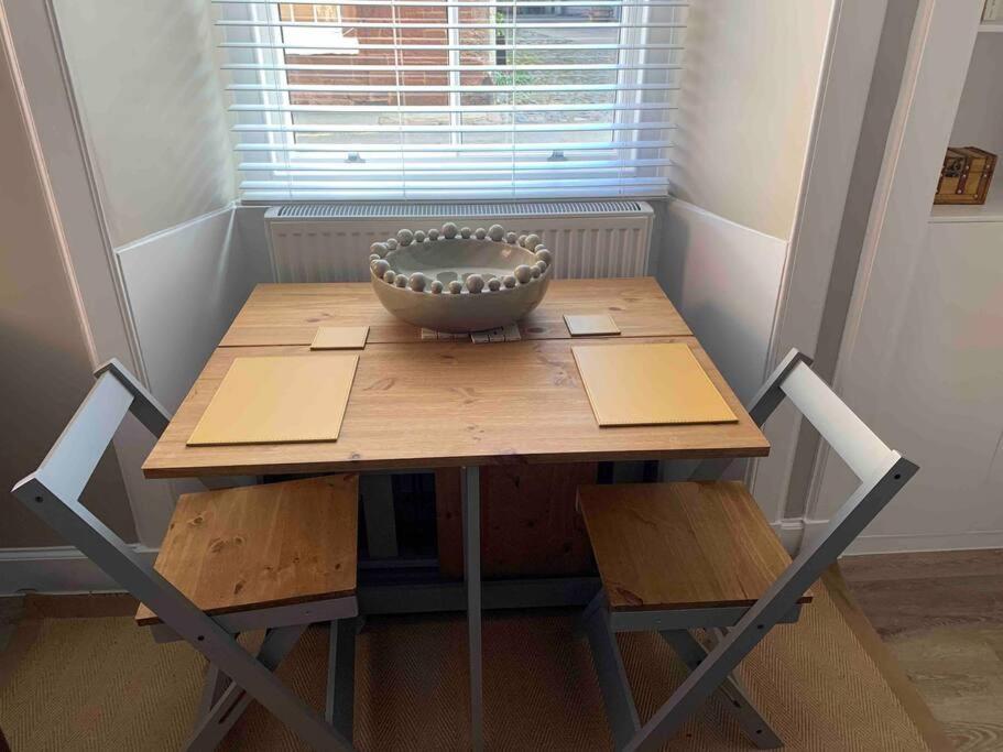 a wooden table with a bowl on top of it at The Beach Pad North Berwick in North Berwick