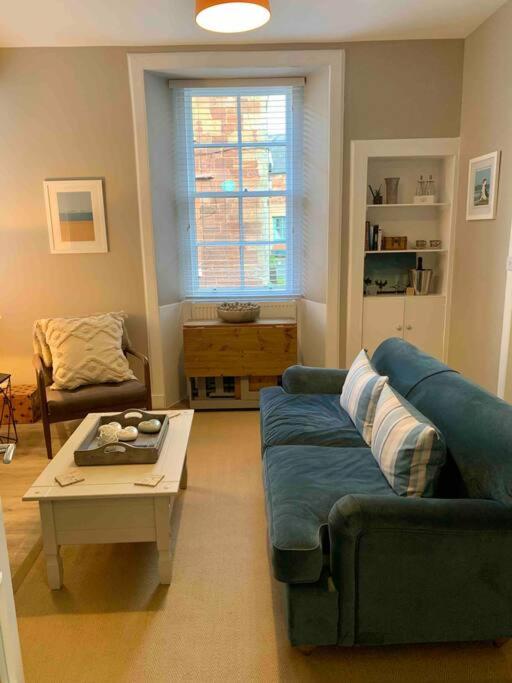 a living room with a couch and a coffee table at The Beach Pad North Berwick in North Berwick
