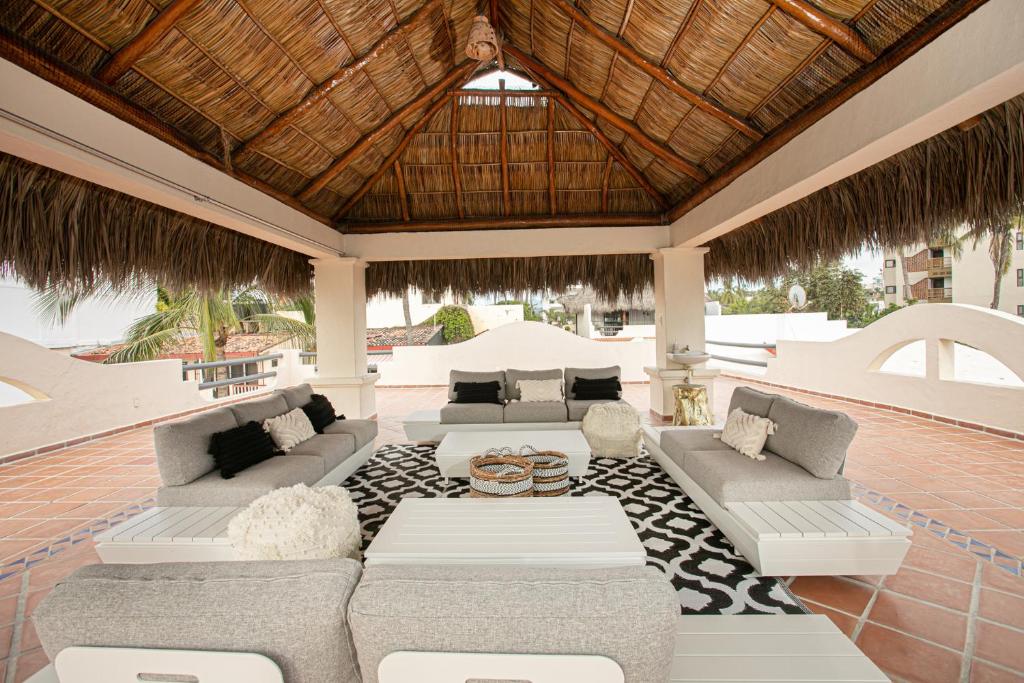 an outdoor patio with couches and a table at Villa Cobojo in Bucerías