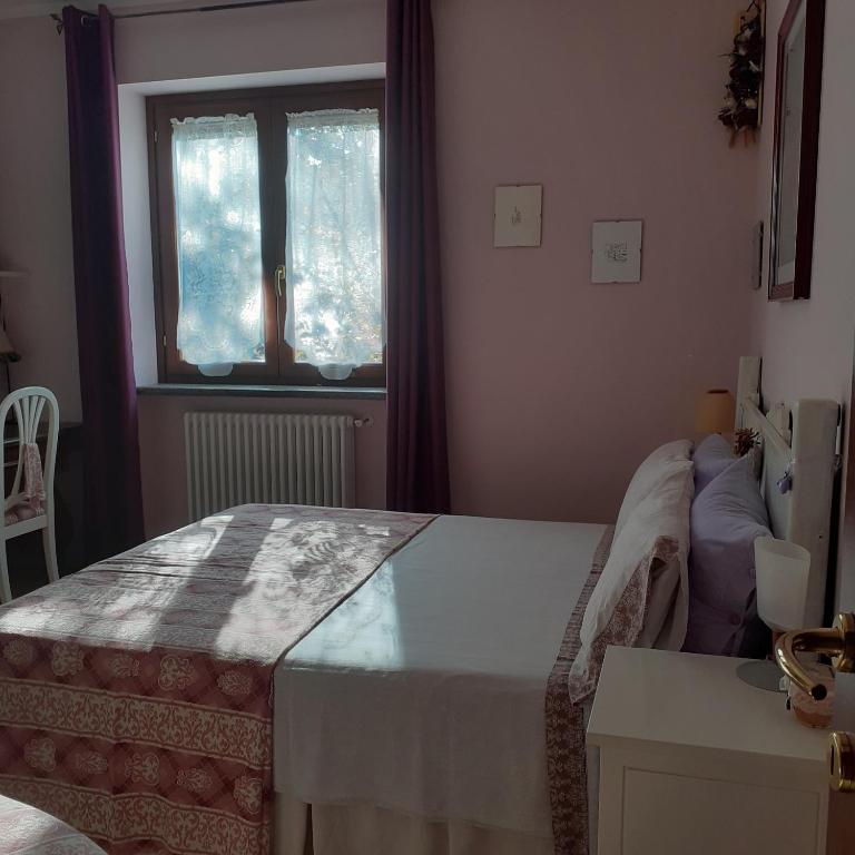Postel nebo postele na pokoji v ubytování La Casa Più Sù