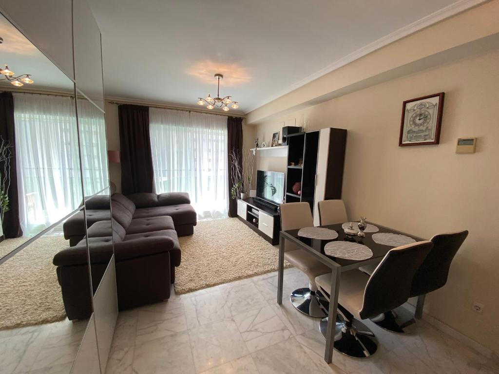 een woonkamer met een tafel en een eetkamer bij Apartamento Benidorm con piscina en la playa in Cala de Finestrat