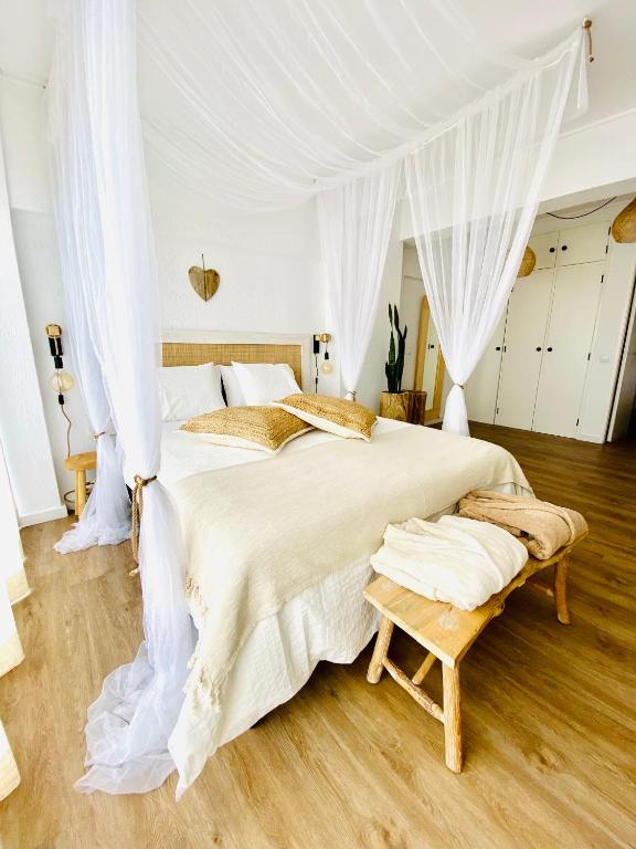 a bedroom with a large bed with a canopy at Caparica Rooftop Beach Apartment in Costa da Caparica