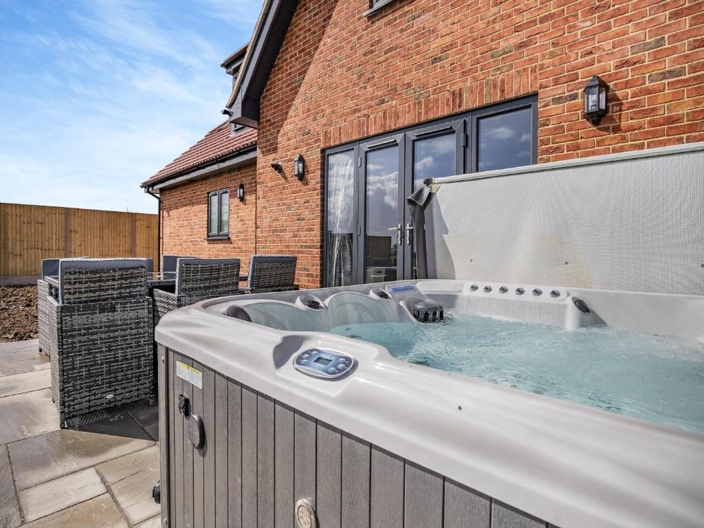 a large hot tub sitting outside of a building at The Pastures - Uk41853 in Maltby le Marsh