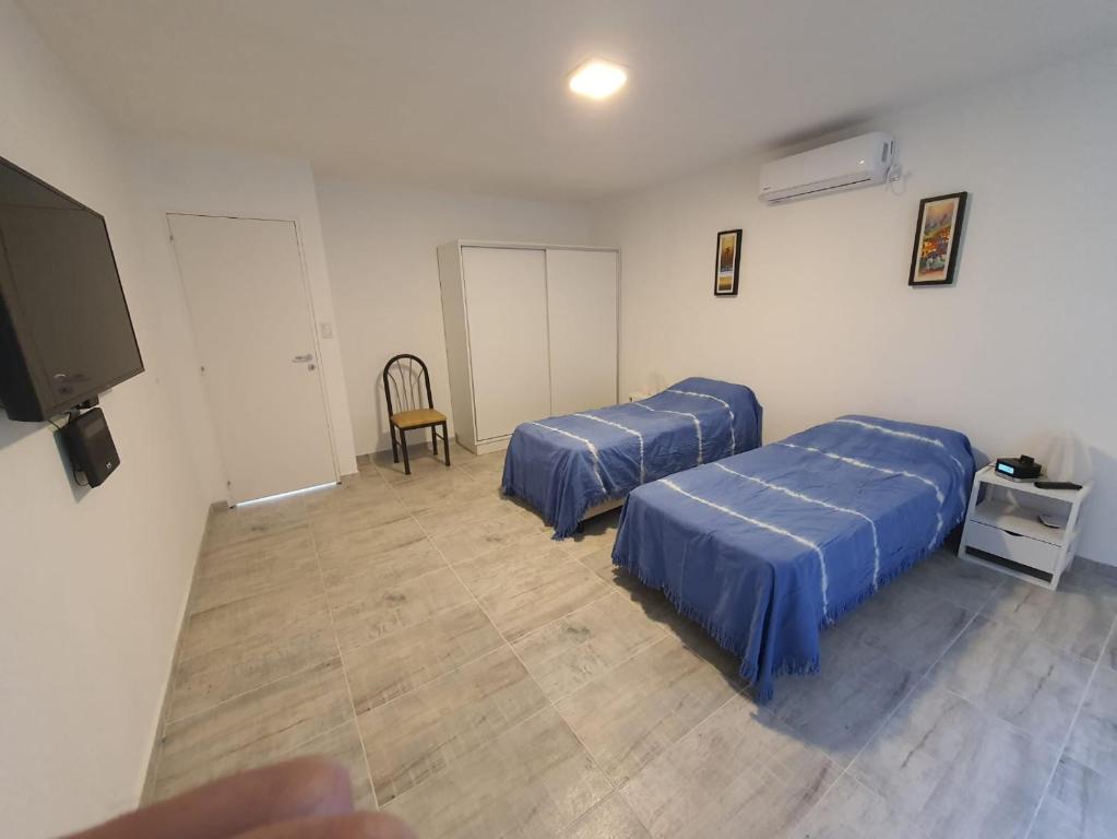 Zimmer mit 2 Betten und einem Flachbild-TV in der Unterkunft Departamento en Arroyito- Córdoba in Arroyito