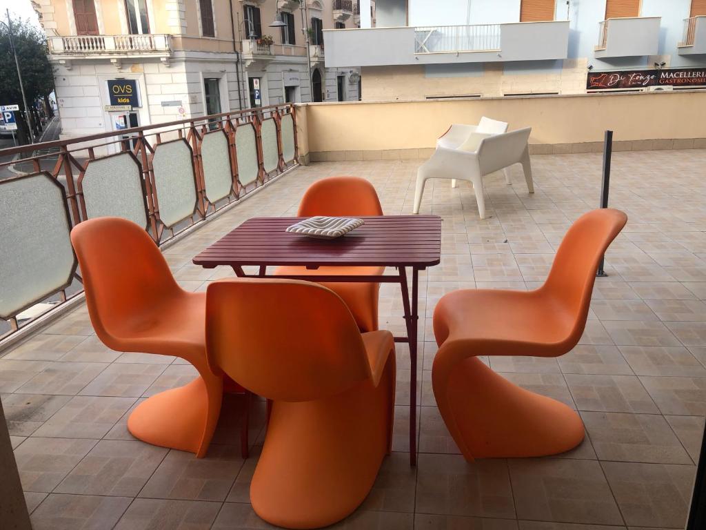 a table and chairs sitting on a balcony at Bed a Cavour in Gaeta
