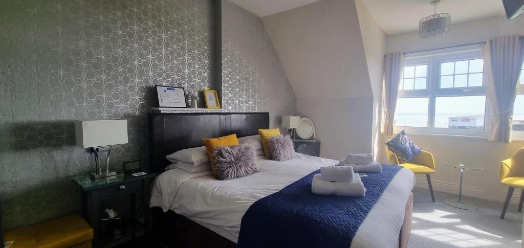 a bedroom with a bed with a blue blanket at Ebor Lodge in Eastbourne