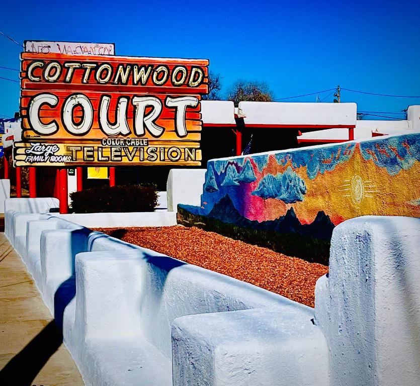 a row of white barriers in front of a sign at Cottonwood Court Motel in Santa Fe