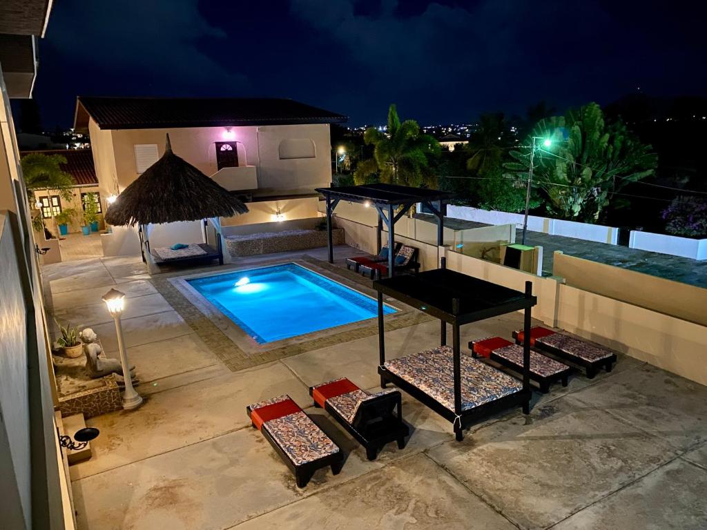 an overhead view of a swimming pool at night at Amalia Apartments in Jan Thiel