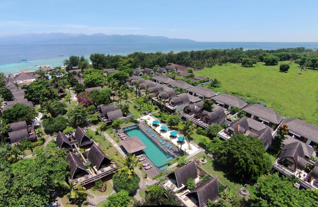 an aerial view of a resort with a pool at Vila Ombak in Gili Trawangan