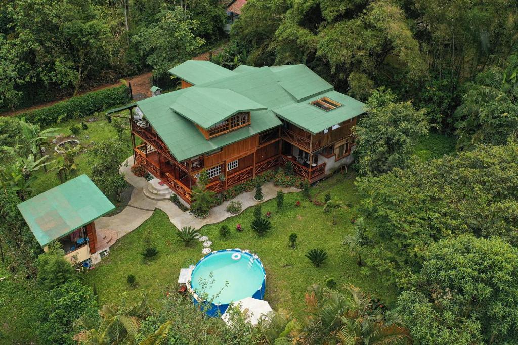 an overhead view of a large house with a pool at The Wooden House Mindo in Mindo