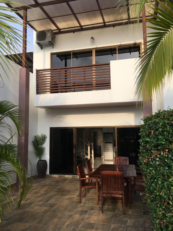 a patio with a table and chairs and a building at VIP Chain Resort in Rayong