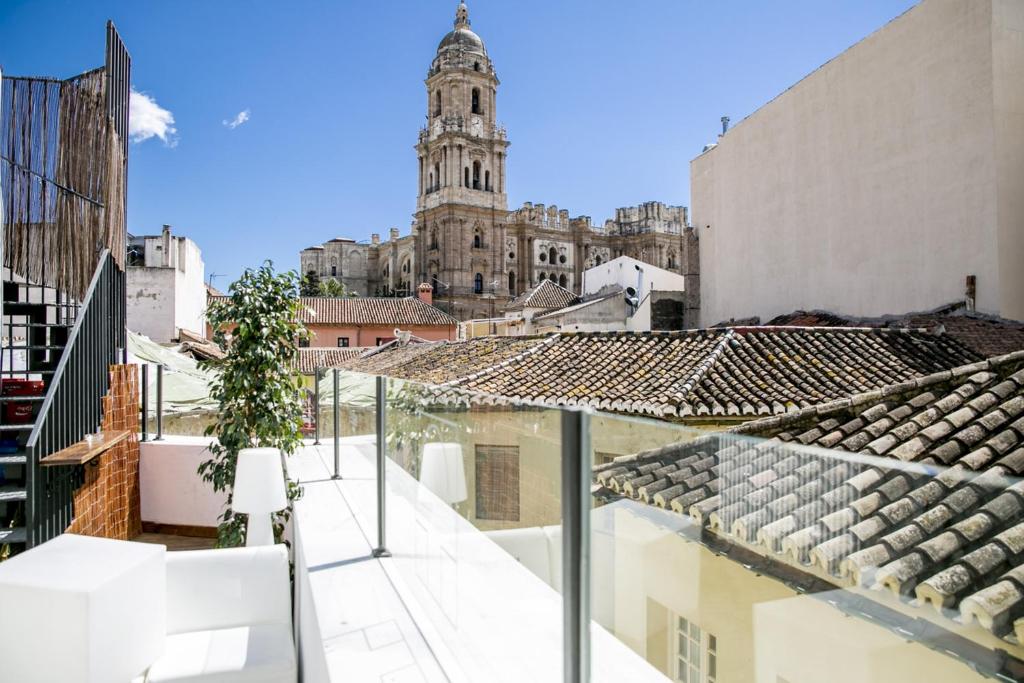 a view of a city from the balcony of a building at Chinitas Urban Hostel in Málaga