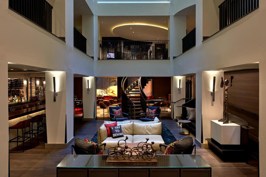 a living room with a couch and a table at Kimpton Hotel Vintage Portland, an IHG Hotel in Portland