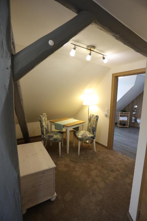 a dining room with a table and two chairs at Pension Alte Scheune in Melsungen