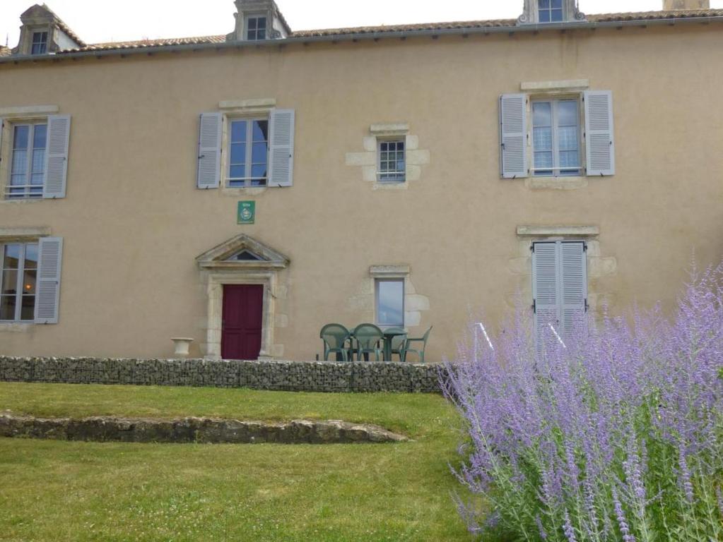 a house with purple flowers in front of it at Les noisettes in Lhommaizé