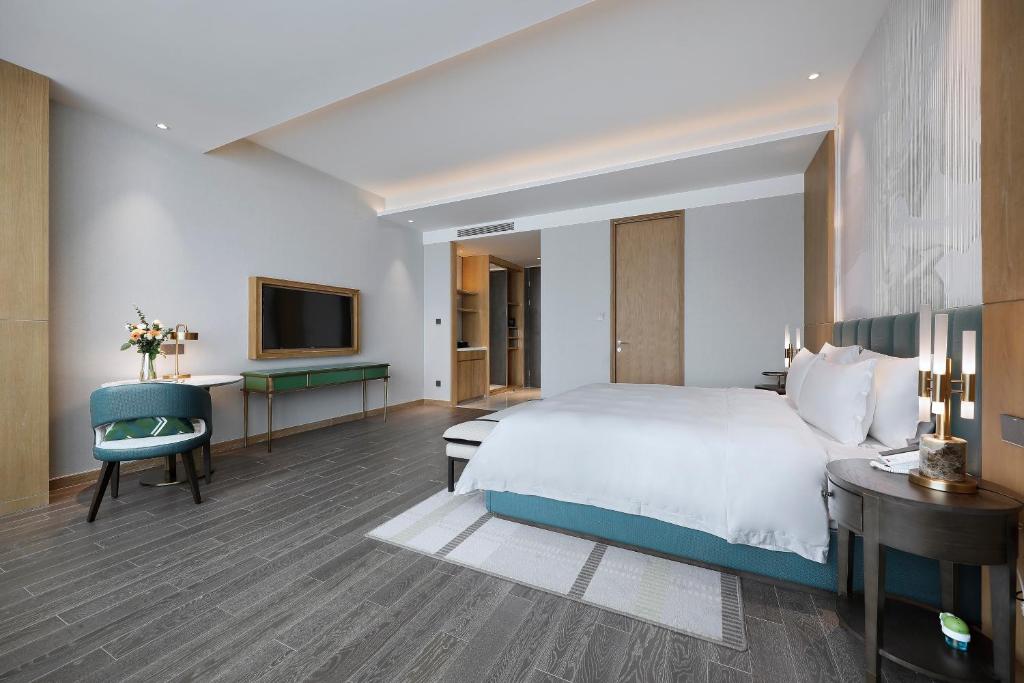 Postel nebo postele na pokoji v ubytování Qingdao Oriental Studio Chuangzhi SSAW Hotel