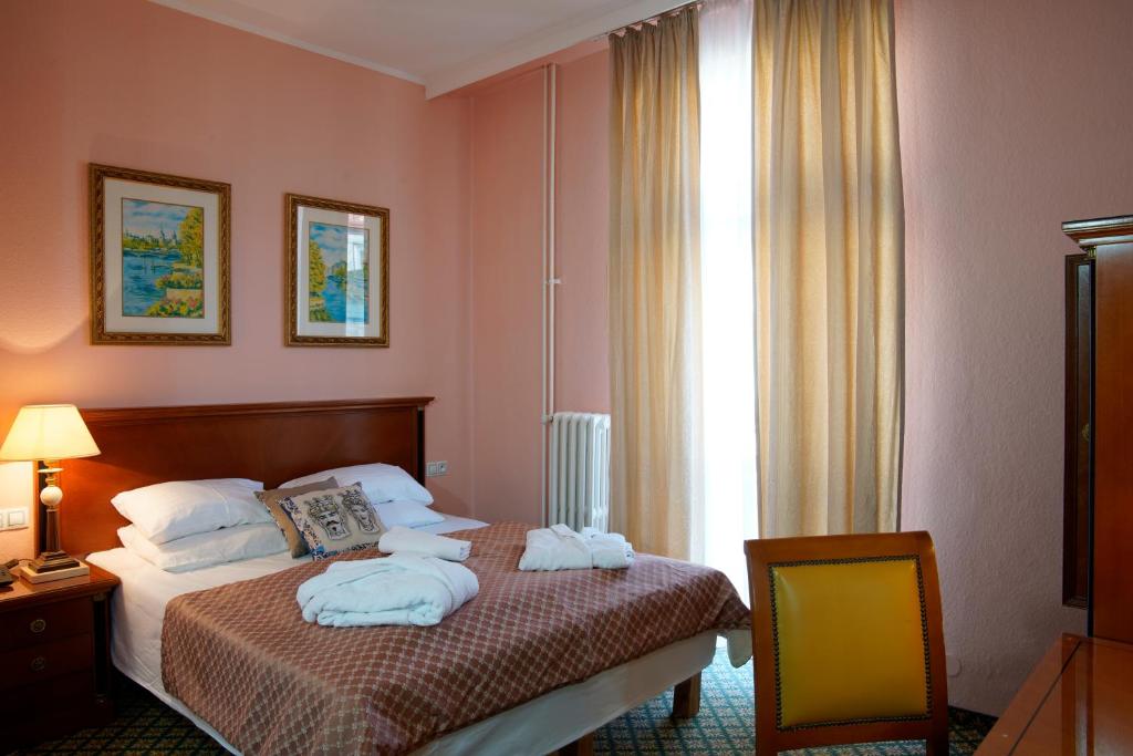 Postel nebo postele na pokoji v ubytování Hotel Villa Lauretta