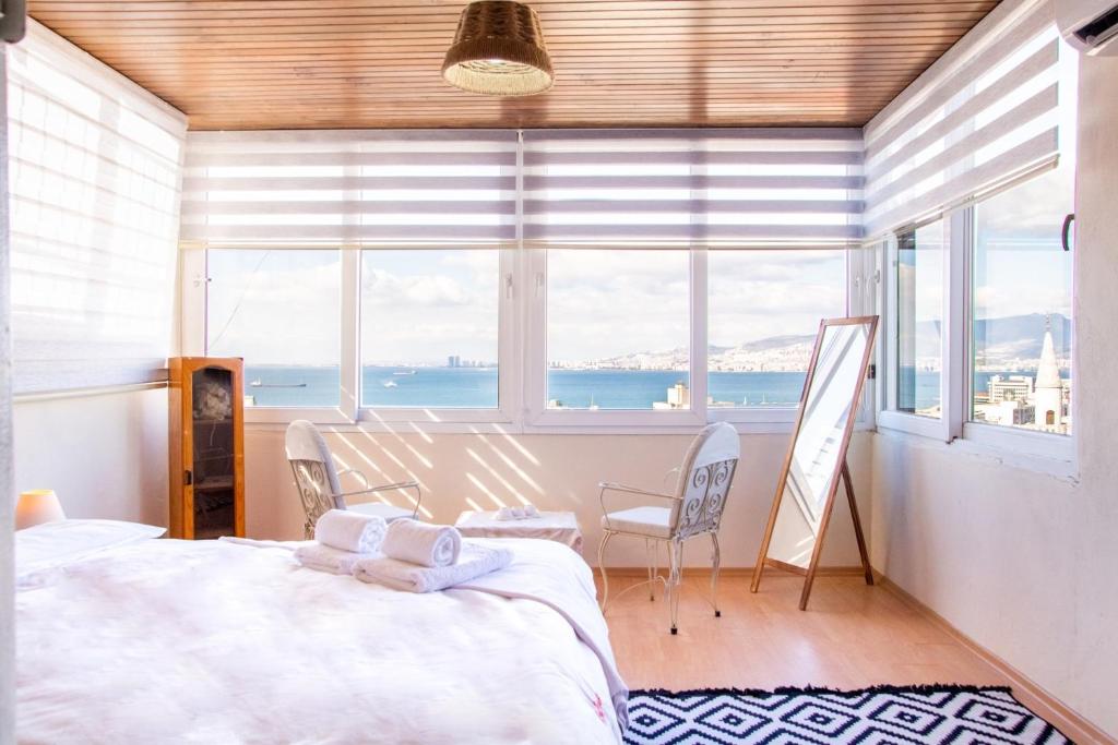 a bedroom with a bed and a view of the ocean at Lovely House with Sea View and Backyard in Izmir