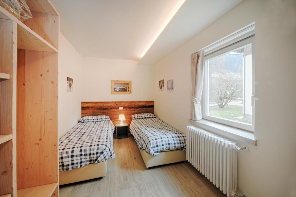 Postel nebo postele na pokoji v ubytování Appartamenti Residence Lares Ossana