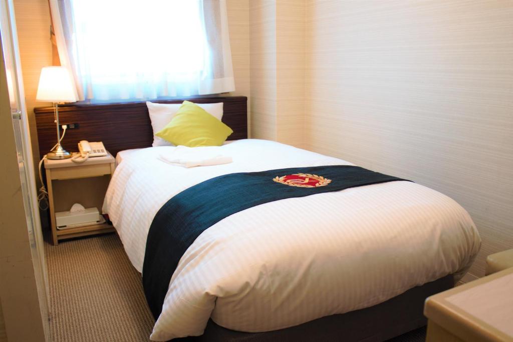 Postel nebo postele na pokoji v ubytování Grand Park Hotel Excel Kisarazu