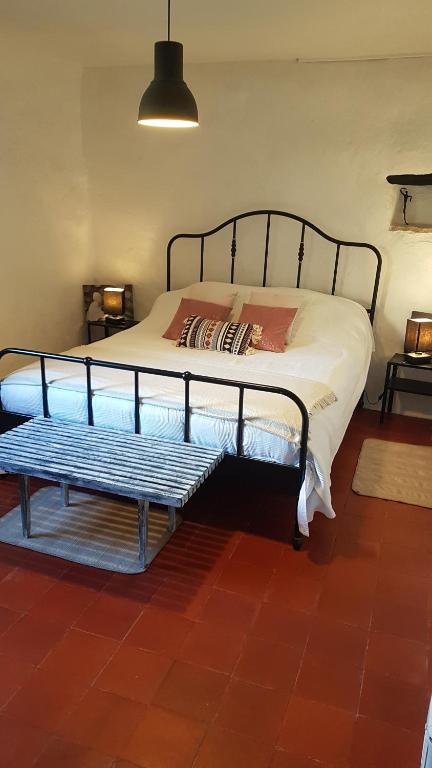 Saint-MontanにあるLe Montadou Saint Montanのベッドルーム1室(ベッド1台、ベンチ付)
