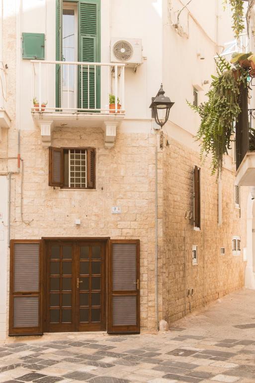 a brick building with two garage doors and a balcony at La Casa dell'oste in Monopoli
