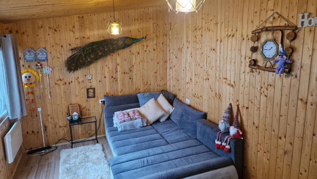 a living room with a blue couch and a clock at D&D ROOM in Bucharest