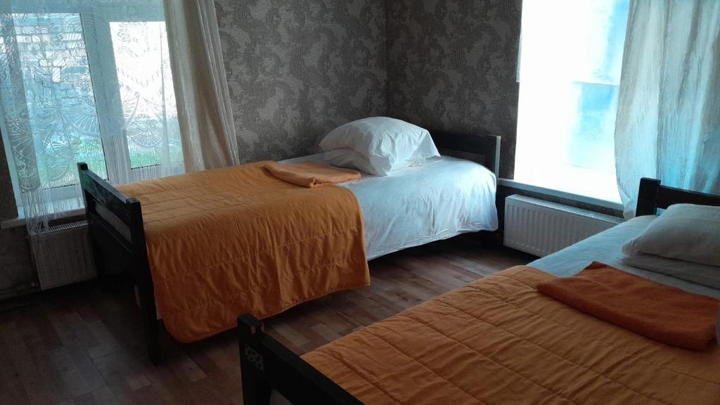 a bedroom with two beds and a window at Comfort flat & parking Gertrudes Street Riga in Riga