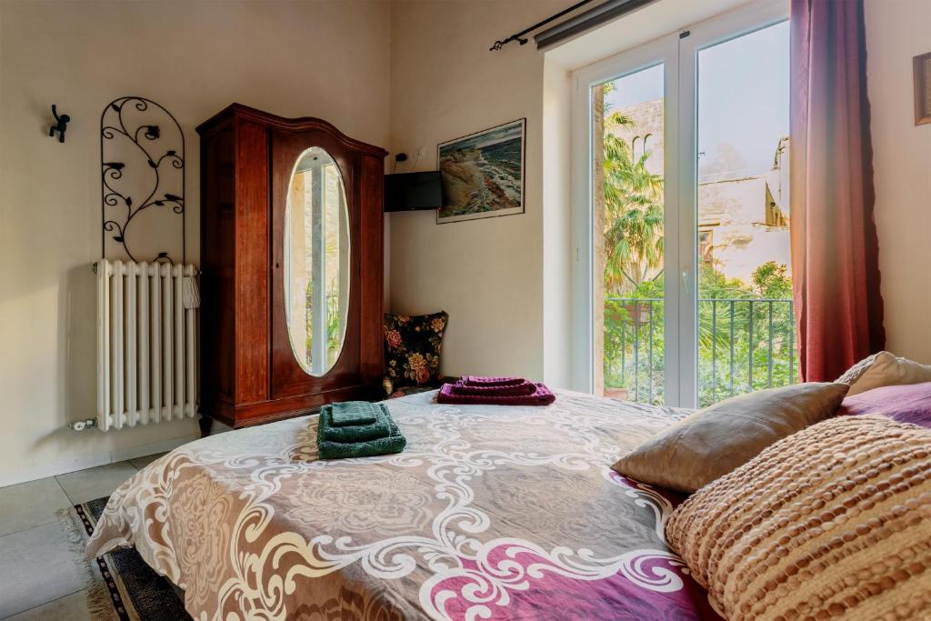 Posteľ alebo postele v izbe v ubytovaní Arimatea Casa Vacanza