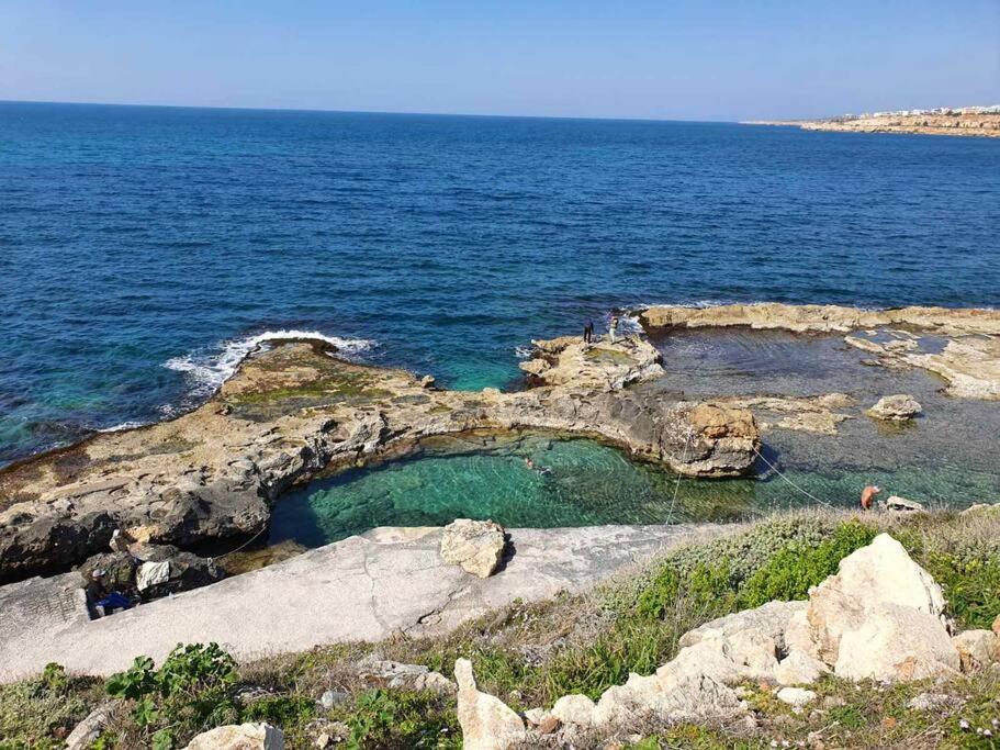 a small pool of water on a rocky shore at Sunny family apartment in Chania close to the sea in Chania