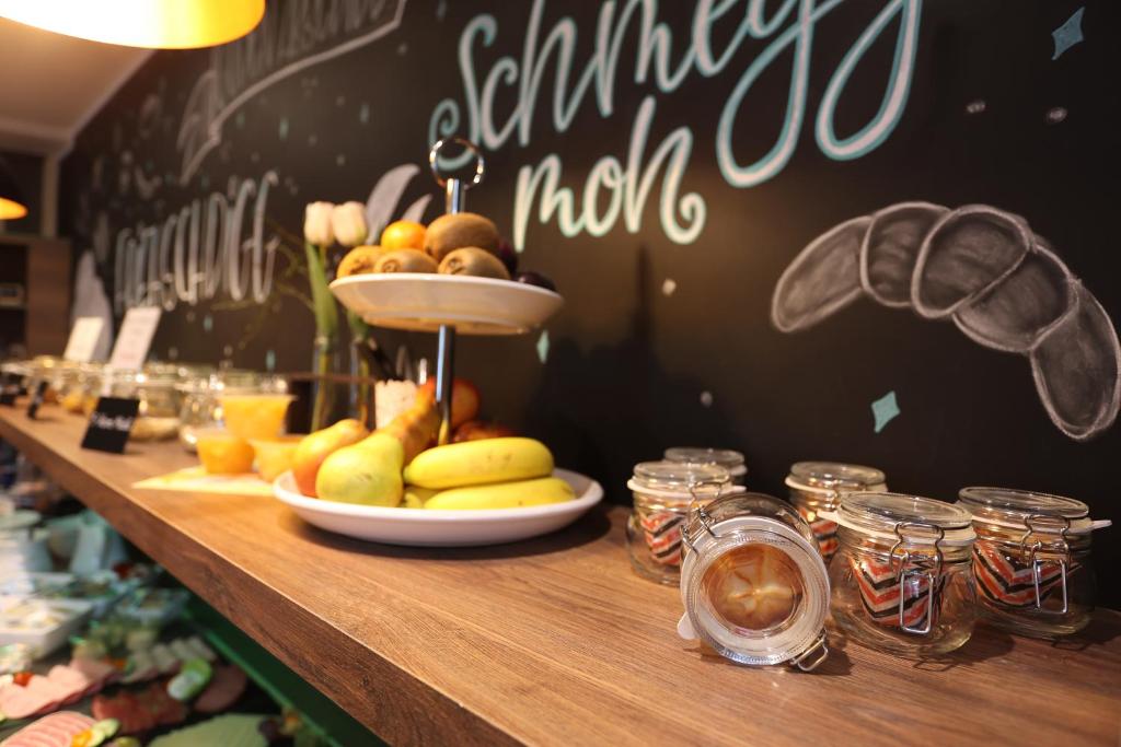 a table with a plate of fruit on it at Pension Alte Scheune in Melsungen