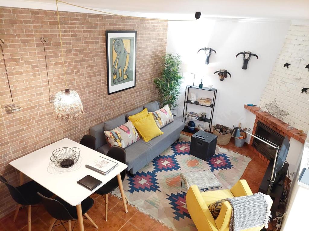 a living room with a couch and a table at Castelinho da Azóia - Checkinhome in Sintra