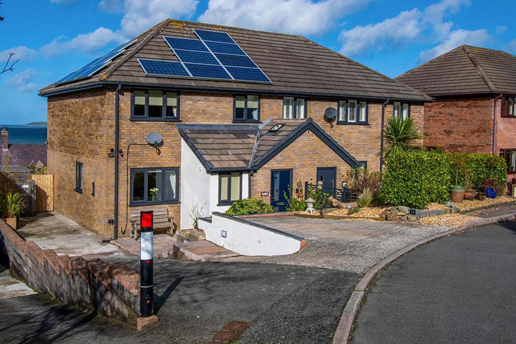 a house with solar panels on top of it at Sunset View in Llanfairfechan