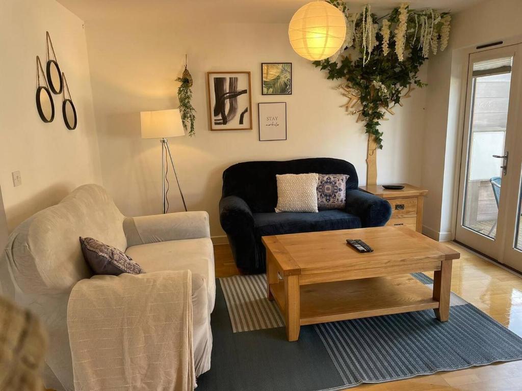 a living room with a couch and a coffee table at House 6 Goldcroft - Walk to Beach & Village, Pet-friendly & hottub in Porthtowan
