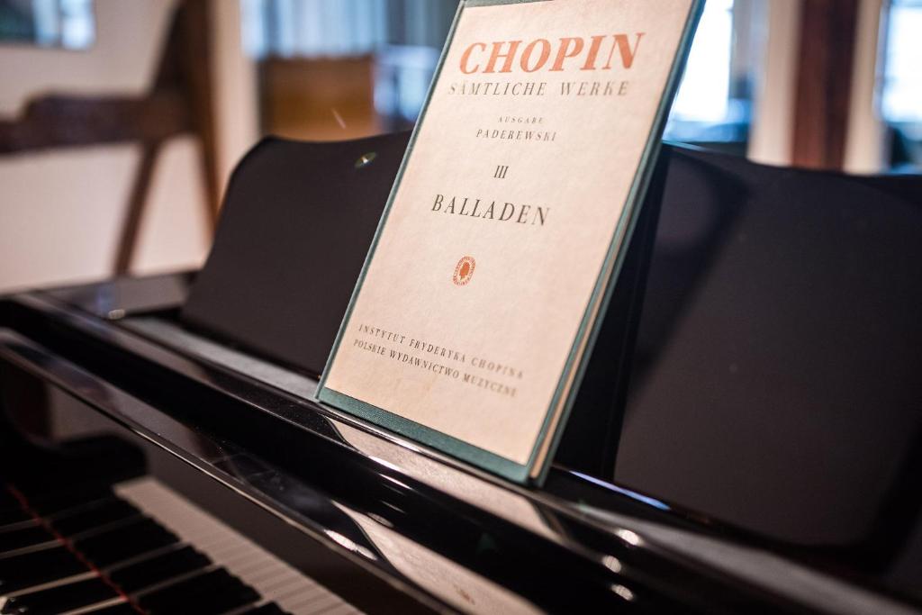 a book is sitting on top of a piano at Jena The Grand Piano Suite in Jena