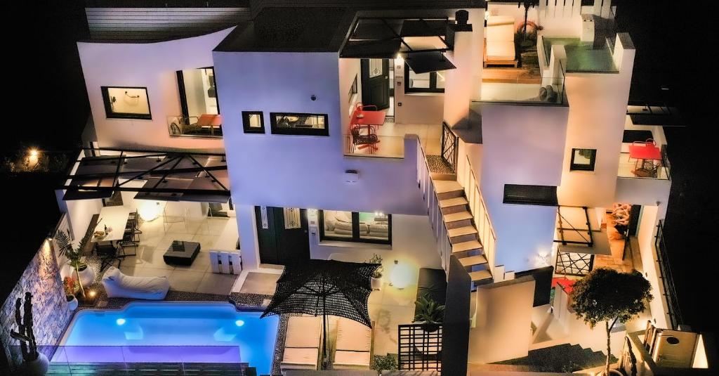 an aerial view of a building with a swimming pool at Smaris Collection Luxury villas/Cosmopolitan villa,heated pool in Sissi