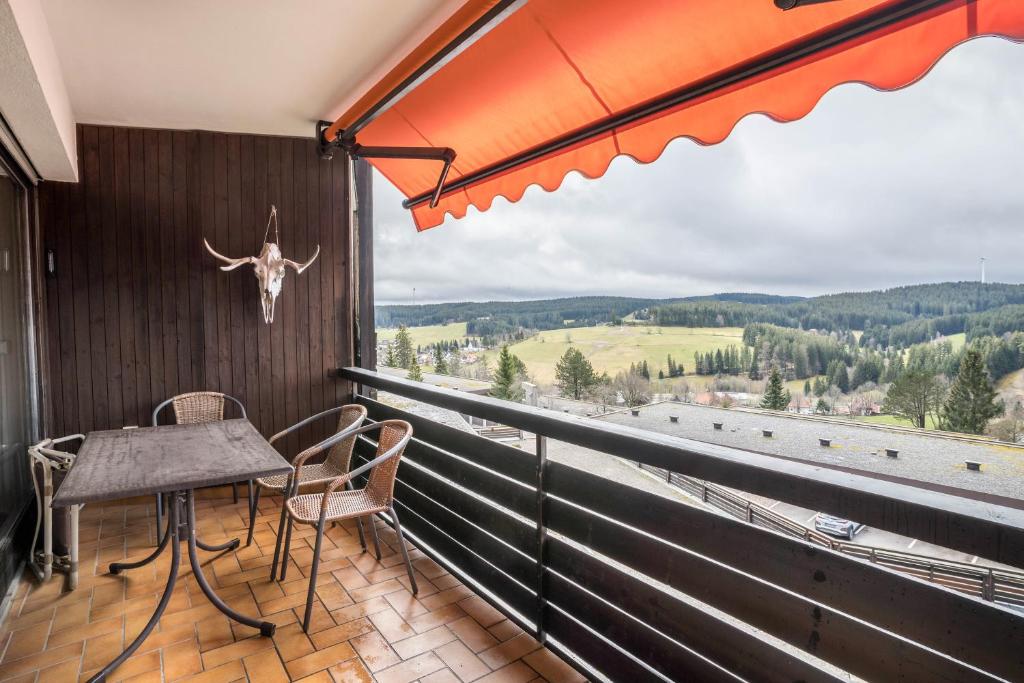 a balcony with a table and chairs and a view at Appartment 160, 80qm in Obertal