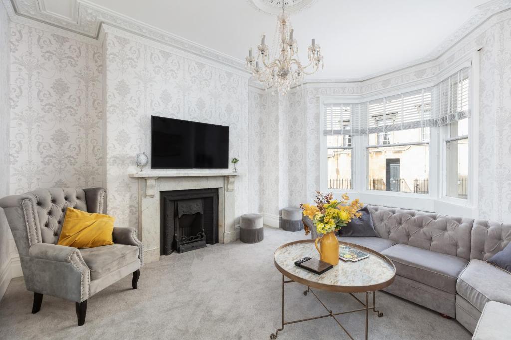 a living room with a couch and a fireplace at 5 Bedroom magnificent Georgian Townhouse- city centre in Bath
