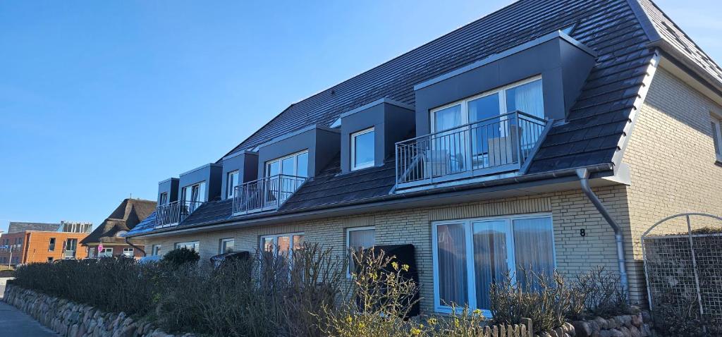 a building with balconies on the side of it at Lornsenhof App 6 in Westerland