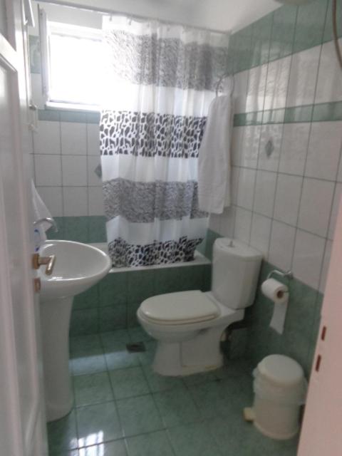 a bathroom with a toilet and a sink at vasia studios in Missolonghi