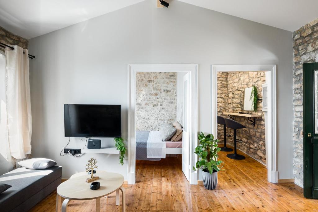 a living room with a couch and a tv at The Greystone House by Konnect, Views to the Sea in Nisakion