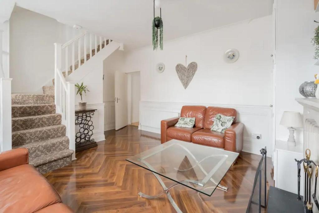 a living room with a couch and a glass table at Unique & Central 3BD - Dublin City in Dublin