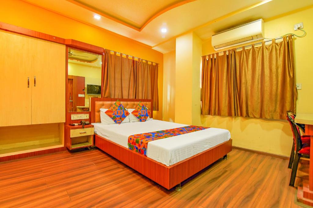 a bedroom with a large bed in a room at FabHotel AG Star in kolkata