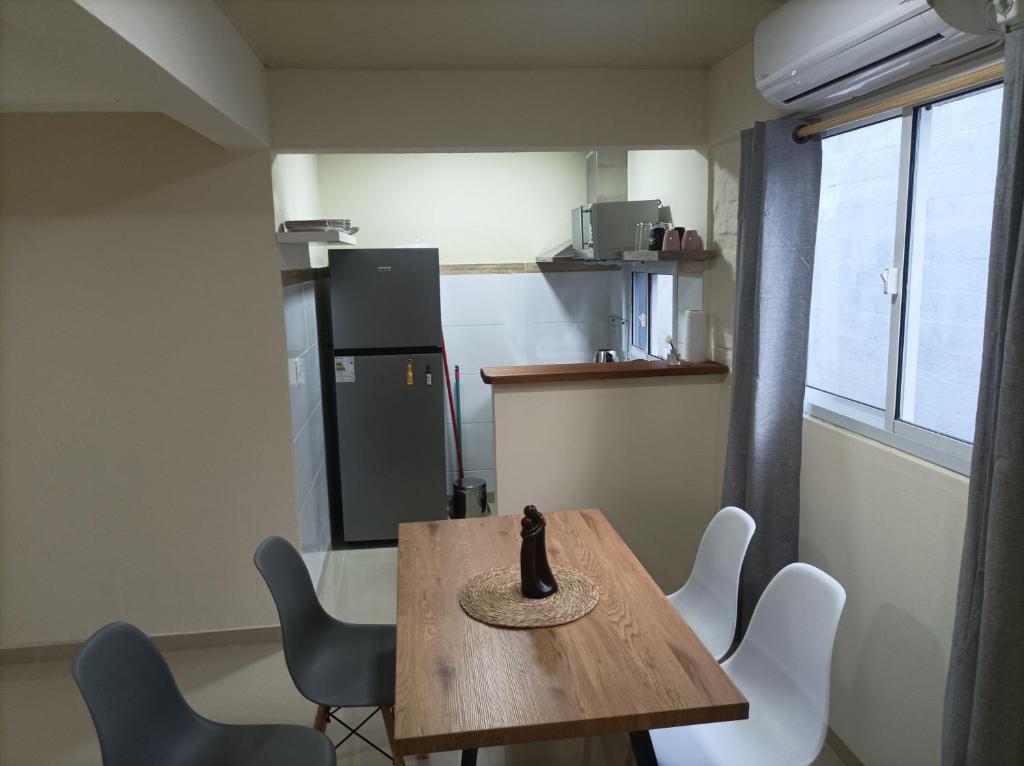 a small kitchen with a wooden table and chairs at Lavalleja 71 II in Mercedes